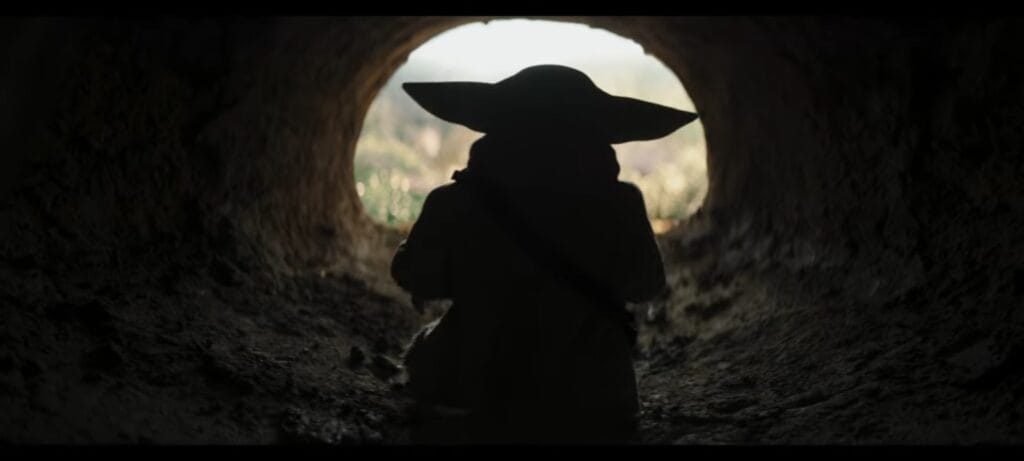 The Mandalorian and Grogu standing in a dark cinematic battlefield with dramatic lighting