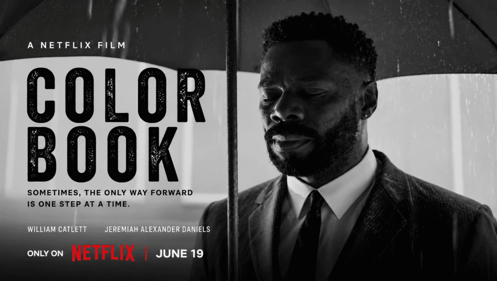 William Catlett as Lucky standing under an umbrella in the rain in the black-and-white Netflix drama Color Book.